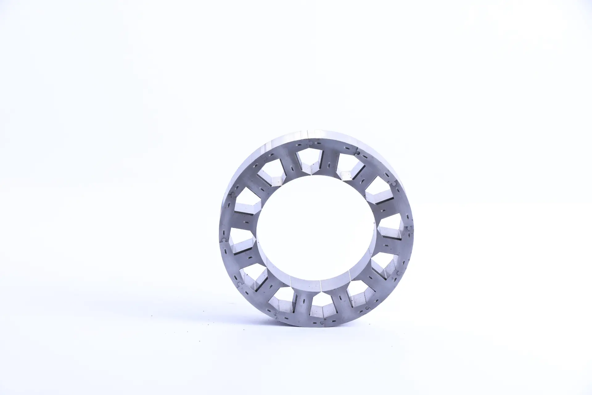 A stator core that is both laminated and segmented for high copper slot filled rate and minimizing eddy current via lamination