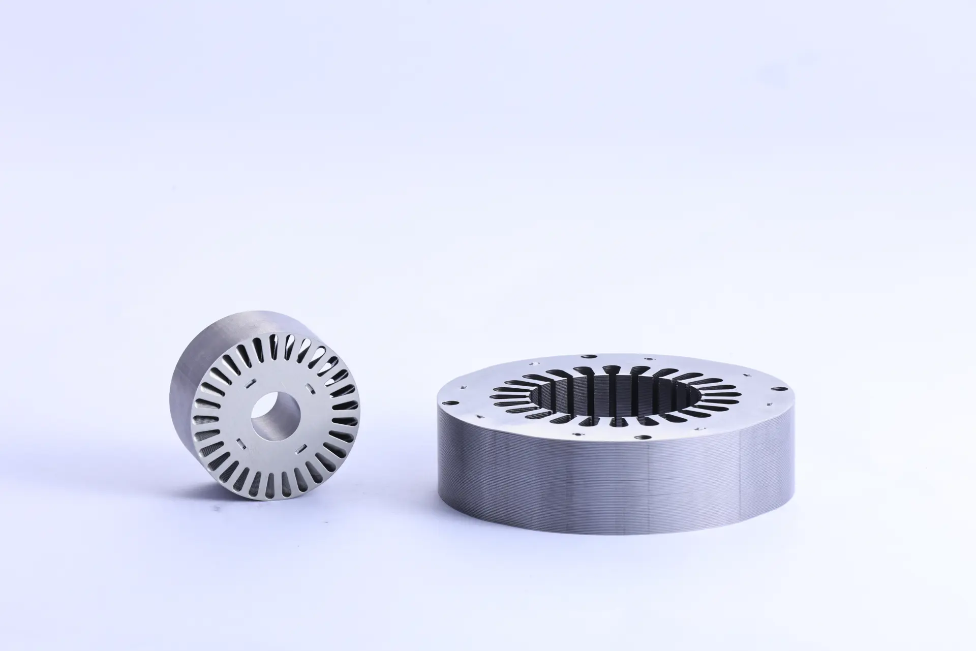 Induction motor stator and rotor stack lamination set featuring precision-engineered electrical steel for optimized magnetic flux and enhanced electric motor efficiency.